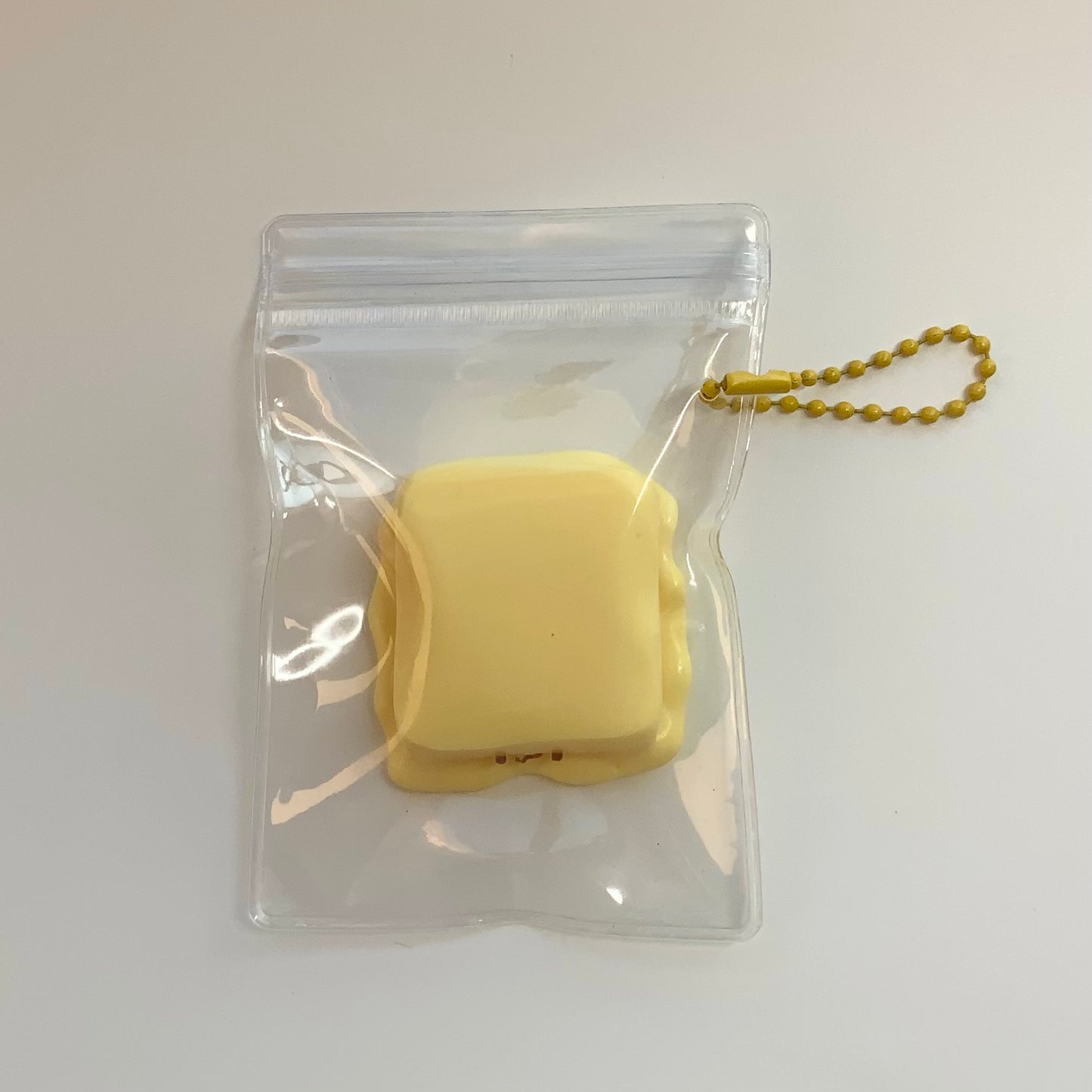 Melted smiling cheese taba squishy toy - Charming Cheese